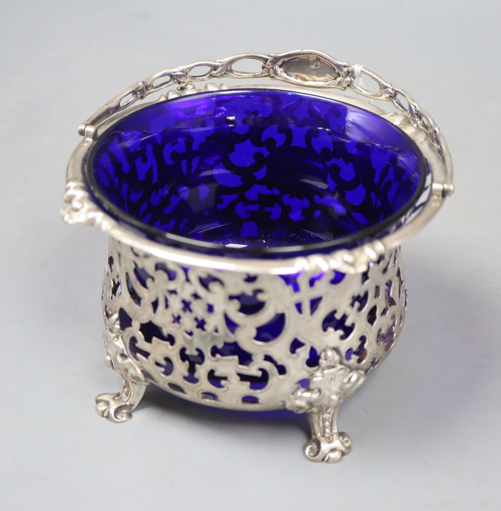 A Victorian pierced silver sugar basket, George John Richards, London, 1850, with blue glass liner, diameter 13.7cm, 8oz.